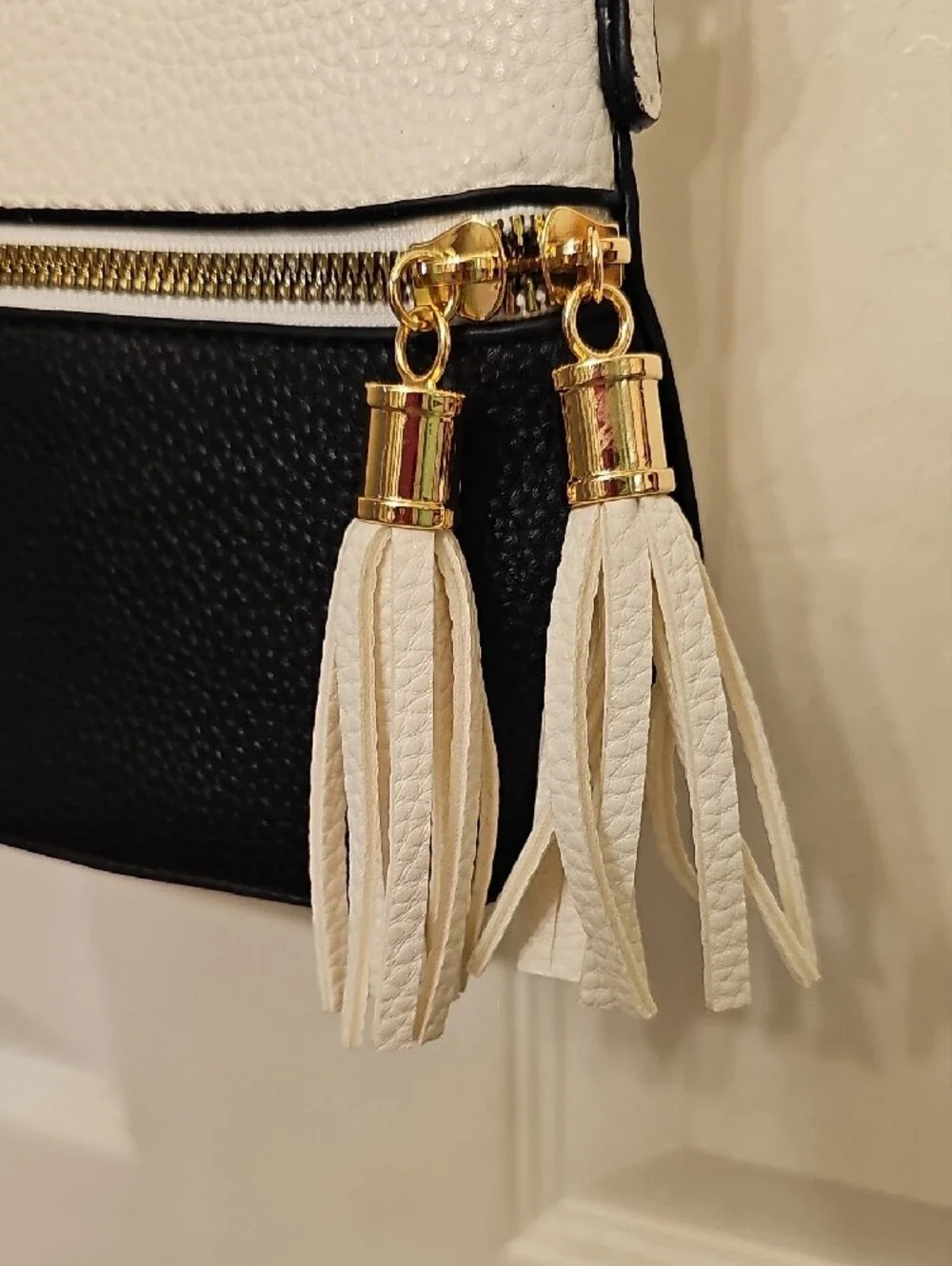 Two-Tone White and Black Crossbody Bag with Tassel Accent